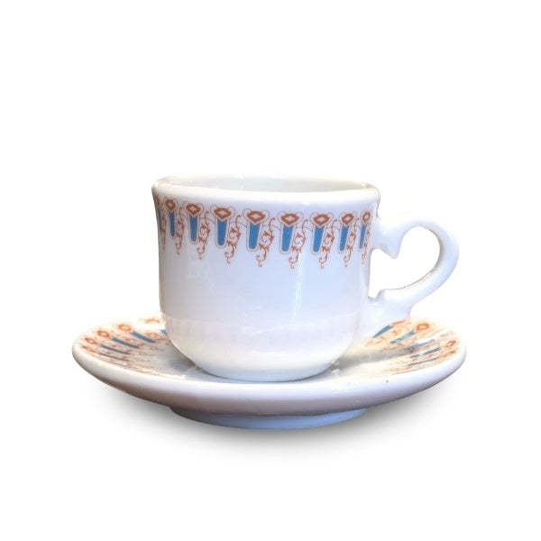 Another angle of the white teacup with light blue and brown swirling arch trim, showing the cup from straight on.