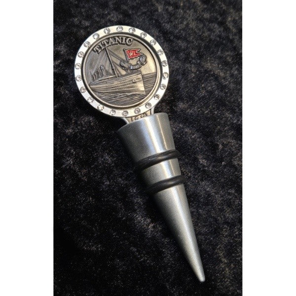 A silver-toned wine bottle stopper with a pewter emblem depicting Titanic and the White Star Line Flag surrounded by clear sparkling gems.