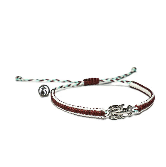 A red macrame bracelet with white accents that glow in the dark and a silvery steel lobster charm.