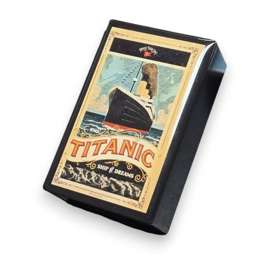 A small black box with an elegantly detailed image of Titanic, like a vintage advertisement, calling it the Ship of Dreams.