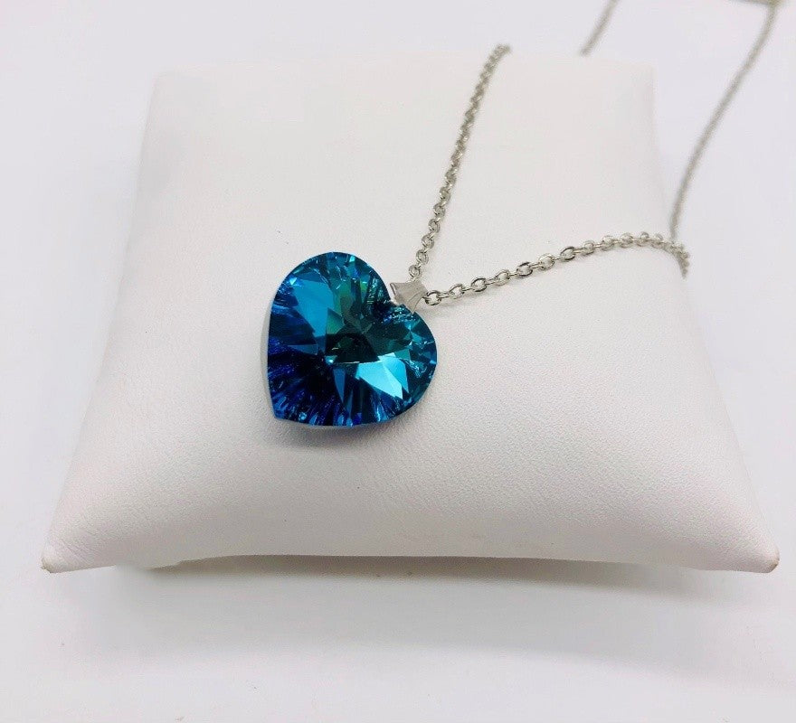 Light blue heart hanging from silvery clasp hardware.