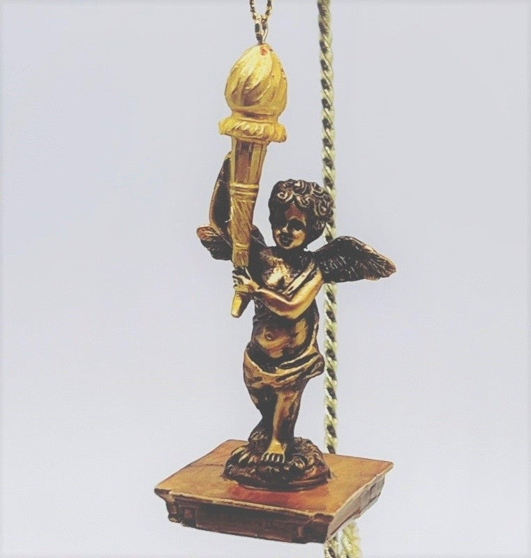 The cherub from the Grand Staircase on Titanic holds a golden torch aloft on this charming molded ornament.