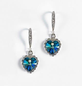 Blue crystal gemstones hang from sparkling silvery hook earrings with clear crystal accents.