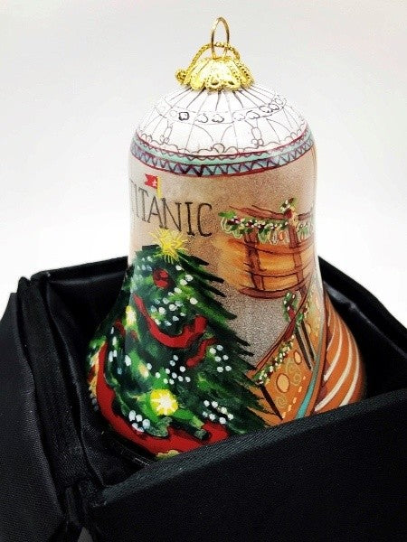 The back of this ornament features a large green Christmas tree with white dots for lights, red garland, and a yellow star on top under our Titanic logo.
