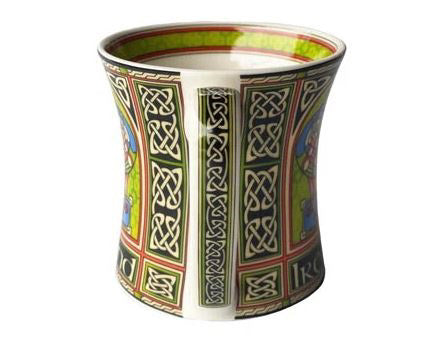 The side of the mug's handle is accented with angular Celtic knots inside a black and green stripe.