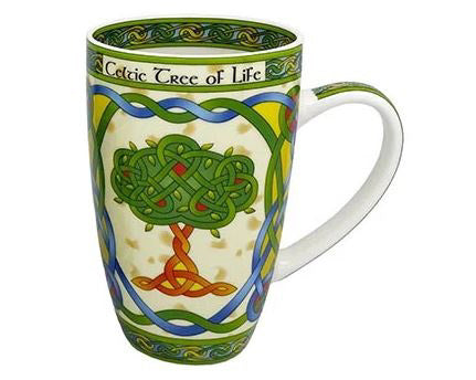 A tall white mug printed with entwined green and blue spirals framing a Celtic Tree of Life design made of colorful knots.