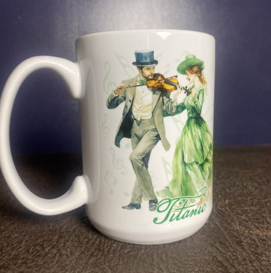 A white ceramic mug printed with a couple in formal attire dancing to a merry Irish fiddle tune.