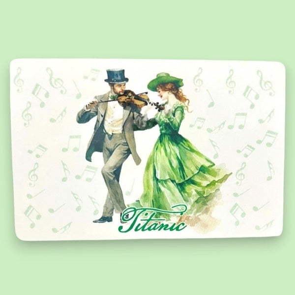 A white rectangular magnet printed with an image of a cheerful Irish couple in formal attire dancing to a merry fiddle tune.