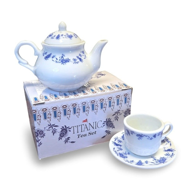 The mini teacup and teapot presented with the box they arrive in, which has a mix of Titanic's first and second class China patterns.