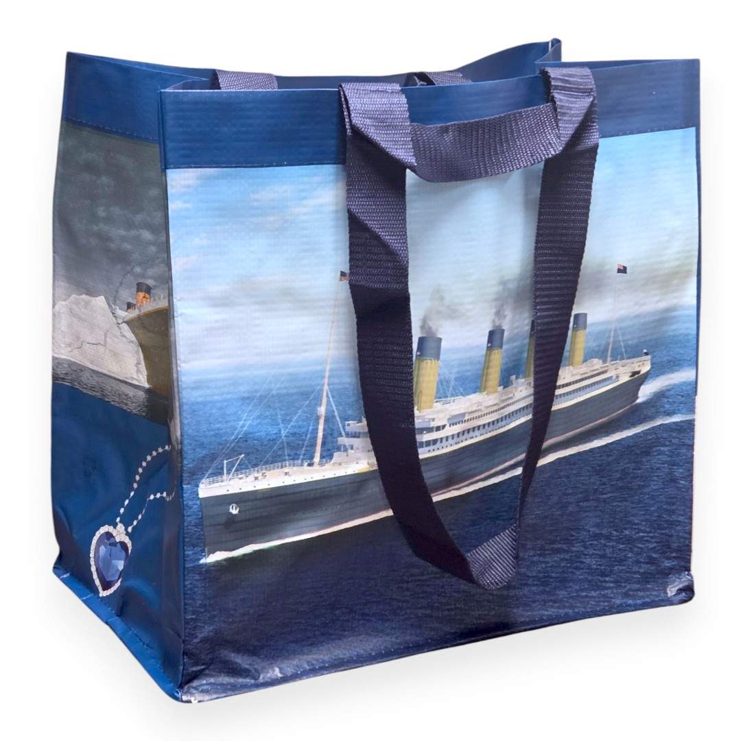 Blue shopping tote with two lengths of handles, one for carrying by hand and one for carrying over the shoulder.