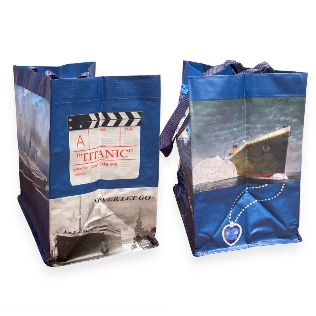 The narrower sides of the shopper tote, still spacious. One side features a Titanic movie clapperboard and black and white image of the real Titanic with the text "Never Let Go". The other side depicts a color image of Titanic hitting the iceberg, and a closeup of a blue heart necklace.