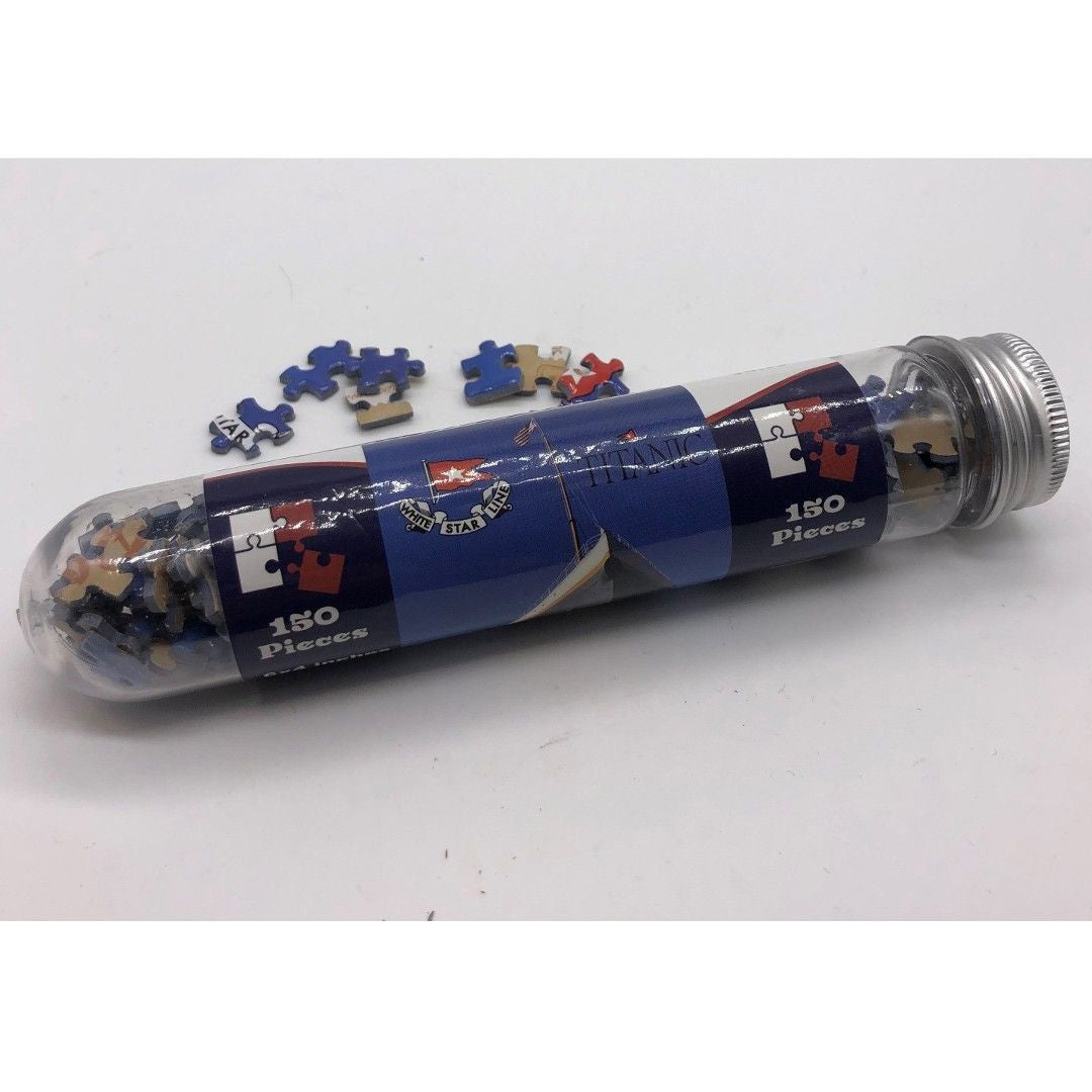 A mini full color Titanic jigsaw puzzle with small pieces in a clear plastic tube.