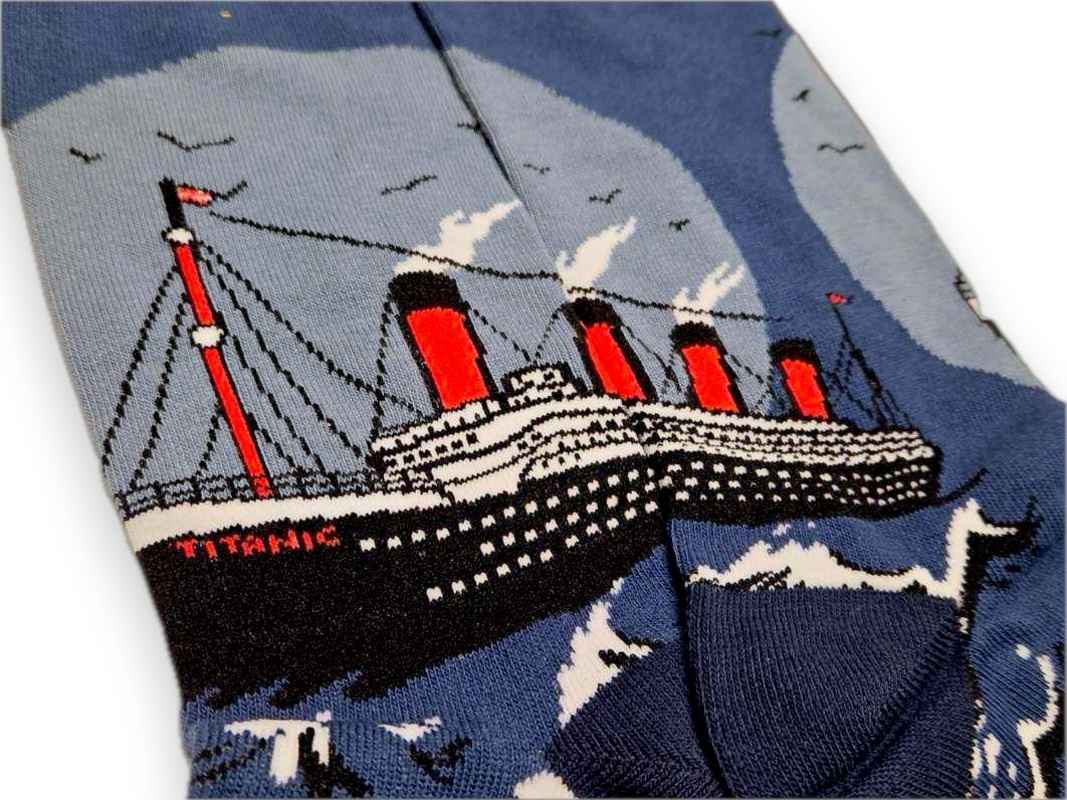 A closeup of the left and right sock next to each other so you can view the full image of the RMS Titanic with all four smokestacks. The ship is printed across the ankle of the socks.