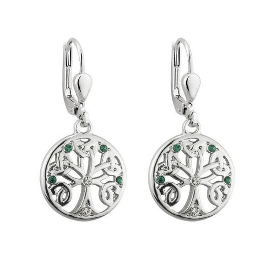 A pair of silver-tone round drop earrings depicting a tree with branches woven into Trinity Knots. They are accented with small clear and green crystals. Hinged lever back hook earrings.