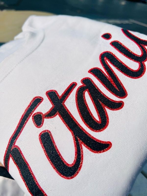 Closeup shows red sparkle detail that outlines the Titanic logo.