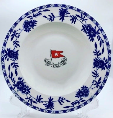 A white bowl with blue floral pattern around the rim, and a red White Star Line flag logo in the center.