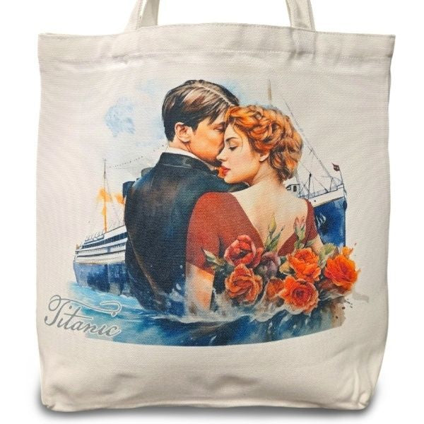 A white canvas tote bag depicting a watercolor image of a man and woman in formalwear from the waist up standing close. The Titanic is in the background, and roses are behind the woman. The bag says Titanic.