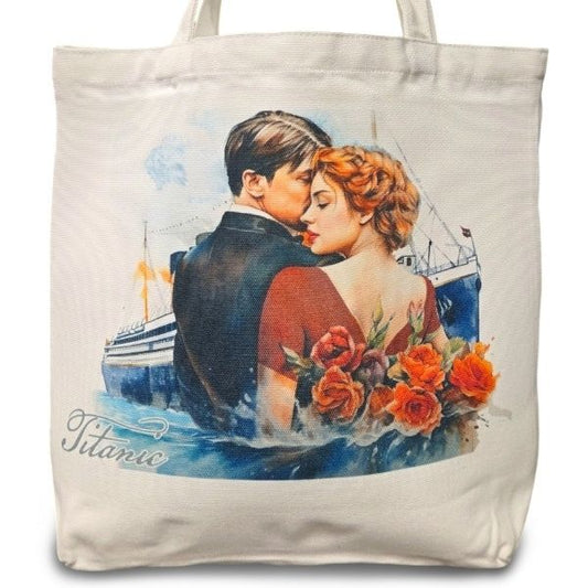 A white canvas tote bag depicting a watercolor image of a man and woman in formalwear from the waist up standing close. The Titanic is in the background, and roses are behind the woman. The bag says Titanic.