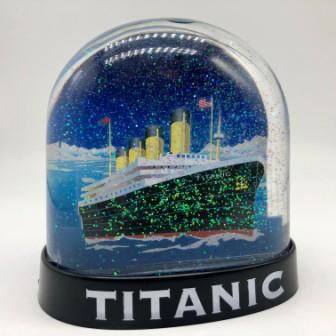 The front of a Titanic water globe with a dome shape and glitter snow filling.