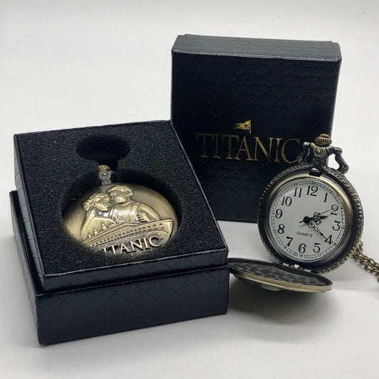Necklace version of an antique brassy pocket watch displayed in its box and open to show a white watch face with swirly black hands and large numbers one through twelve.
