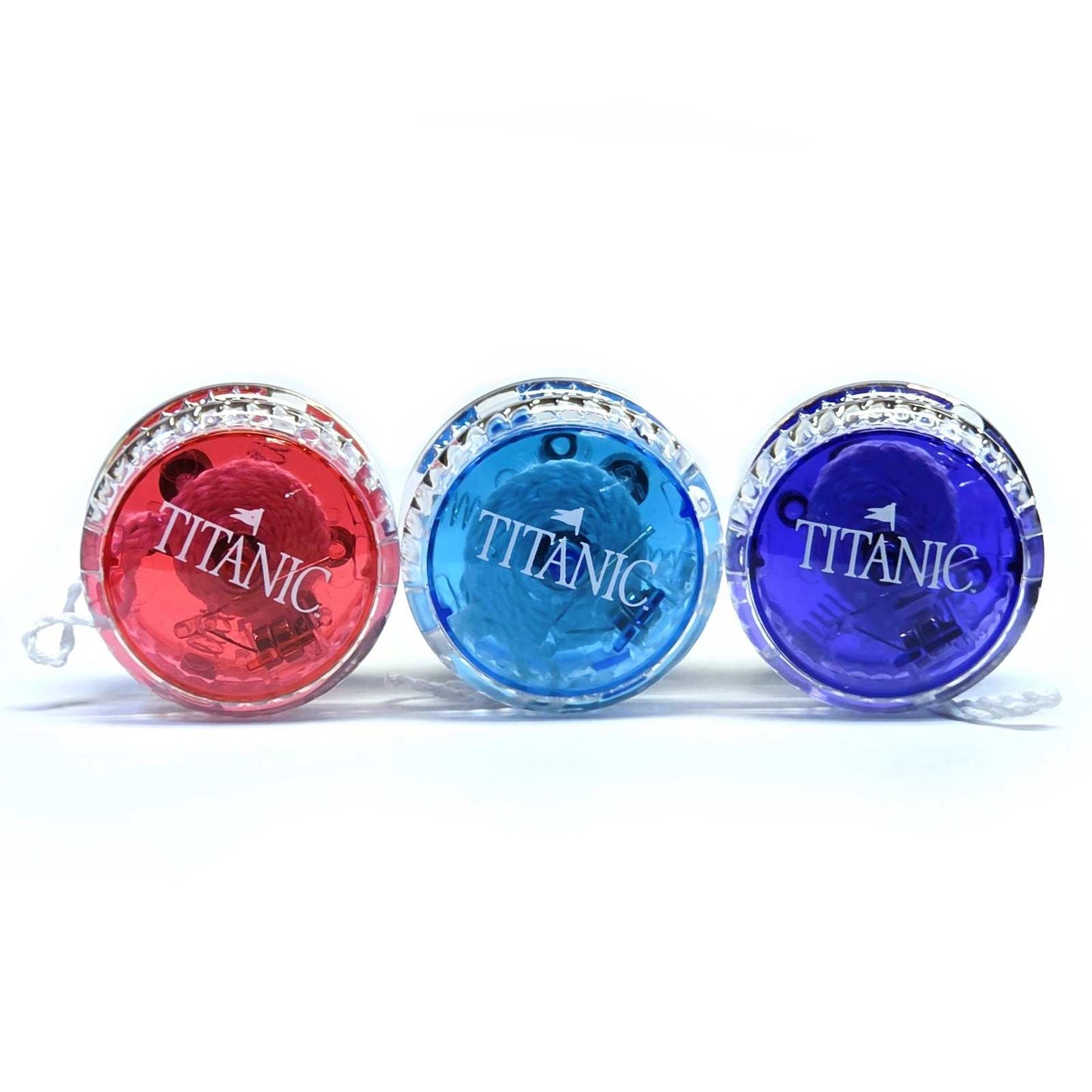 Three colorful Titanic transparent yoyos on display.