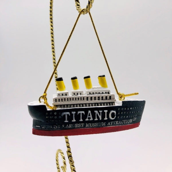 The small ship ornament says "Titanic World's Largest Museum Attraction" on the sides and includes a gold string to hang and display.