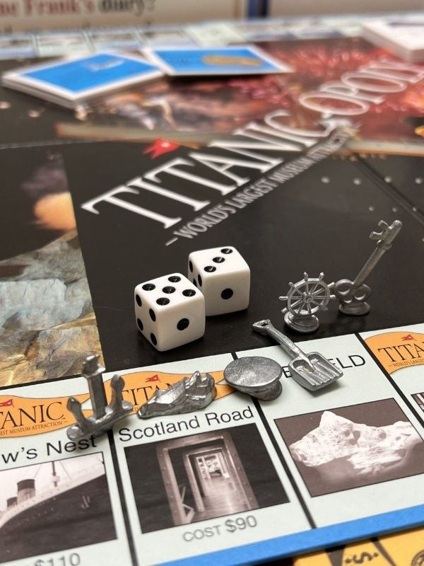 Custom pieces for Titanic-opoly include a captain hat, anchor, key, shovel, and ship's wheel. 