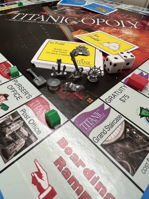 A closeup showing the pieces, Ice Field cards, and red and green houses on the spaces. The beginning space is the Post Office, and the ending space is the Grand Staircase.