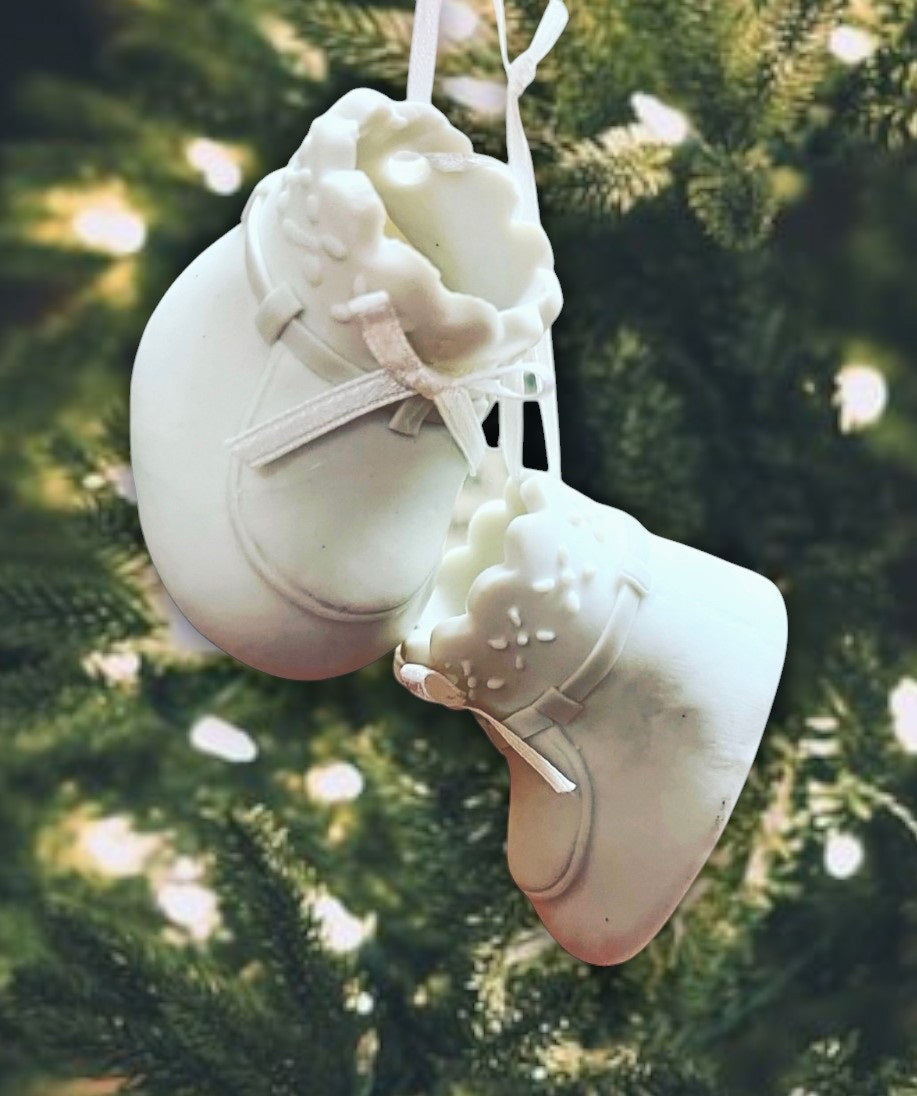 White baby shoes ornament with ribbon laces.