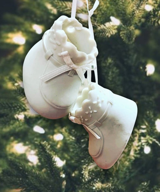 White baby shoes ornament with ribbon laces.