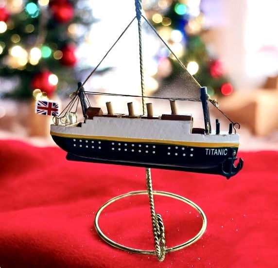 A handmade wooden Titanic with painted details and hanging anchor.