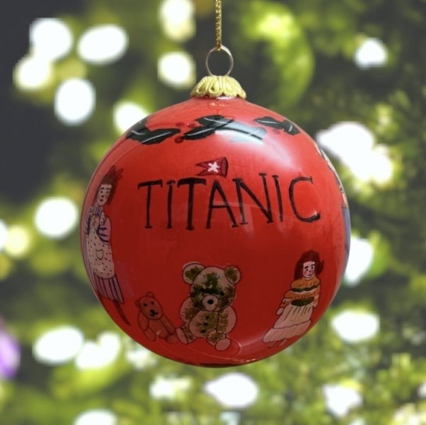 A girl looks at plush toys and dolls under a Titanic logo.
