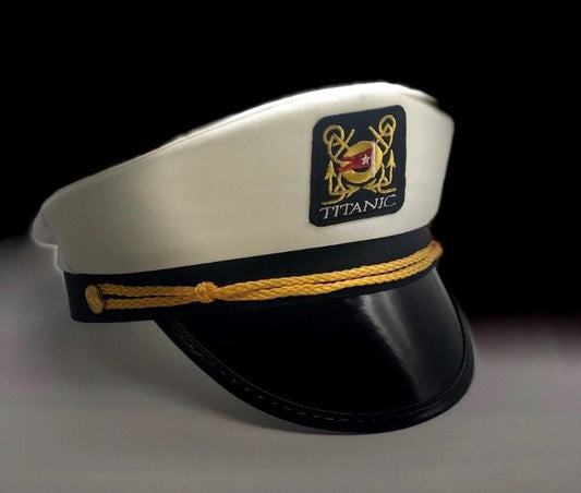 A white and black captain hat with gold rope detail and a Titanic emblem patch.